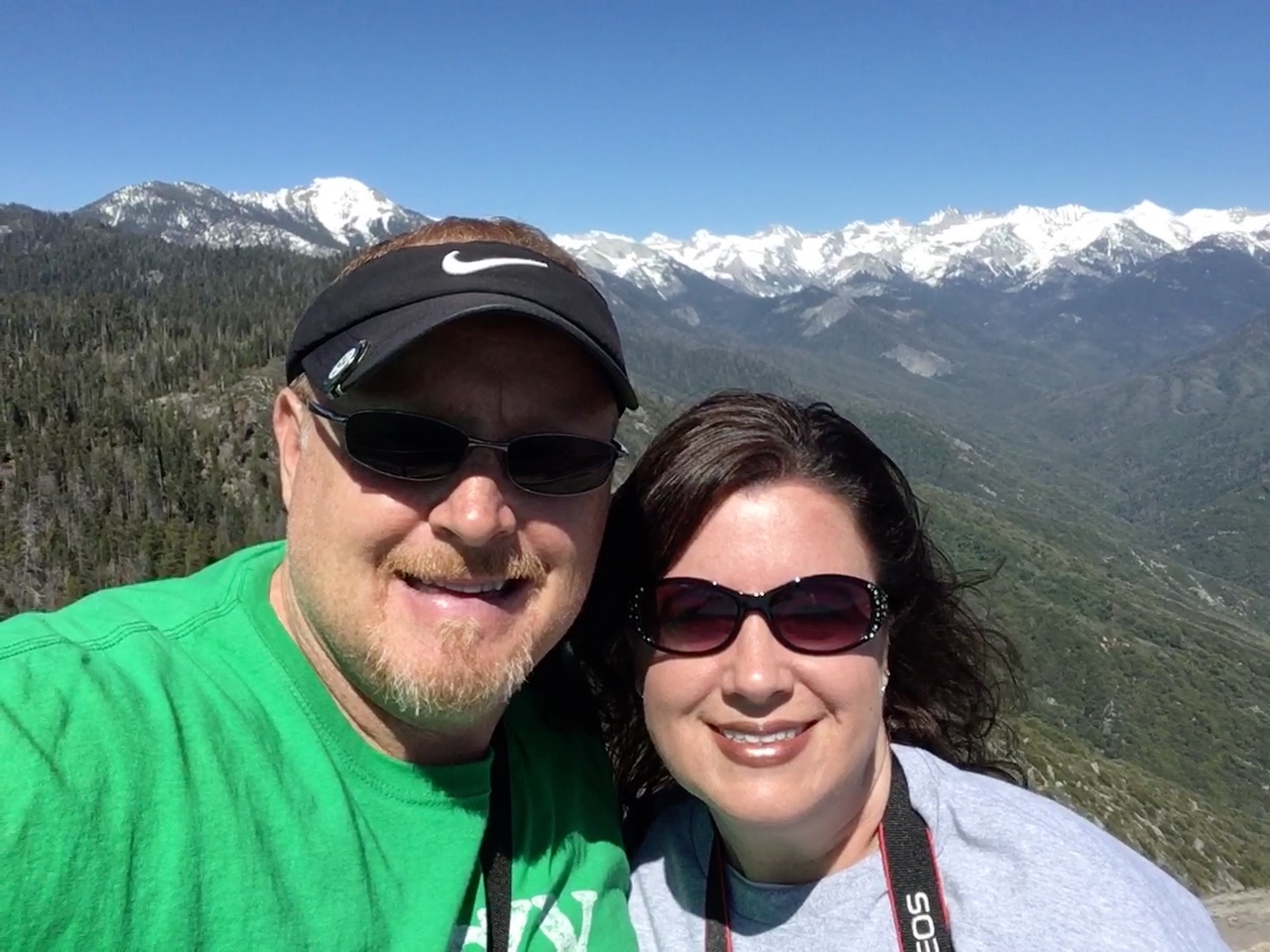 Smiling couple at top of Morro Rock in Sequoia National Park.